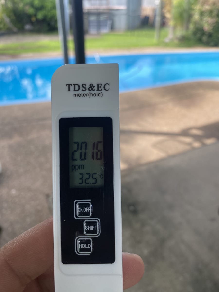 Digital pool water testing meter reading chlorine, pH and total dissolved solids