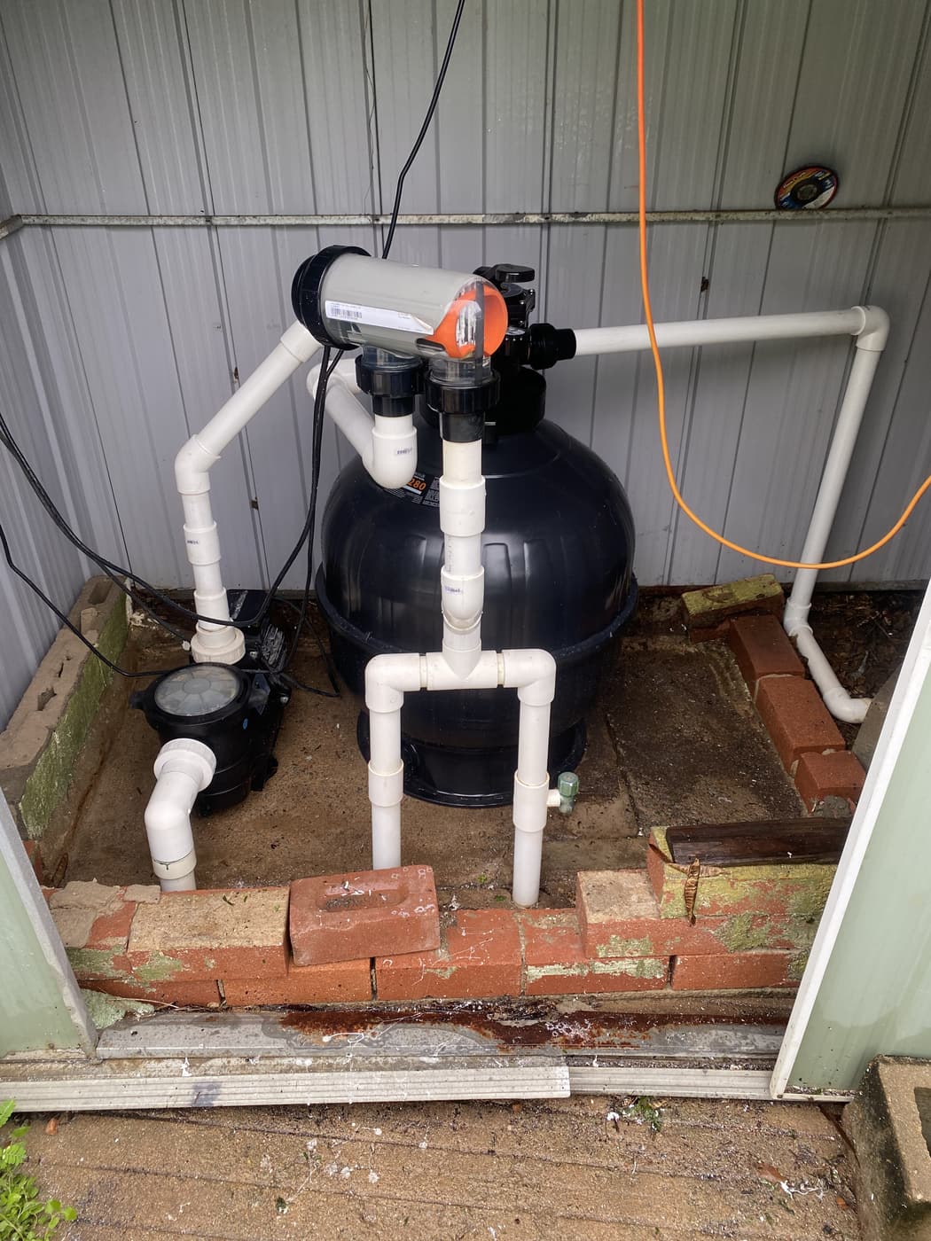 Sand filter, multiport valve, pump and plumbing — typical Townsville pool equipment inspection setup
