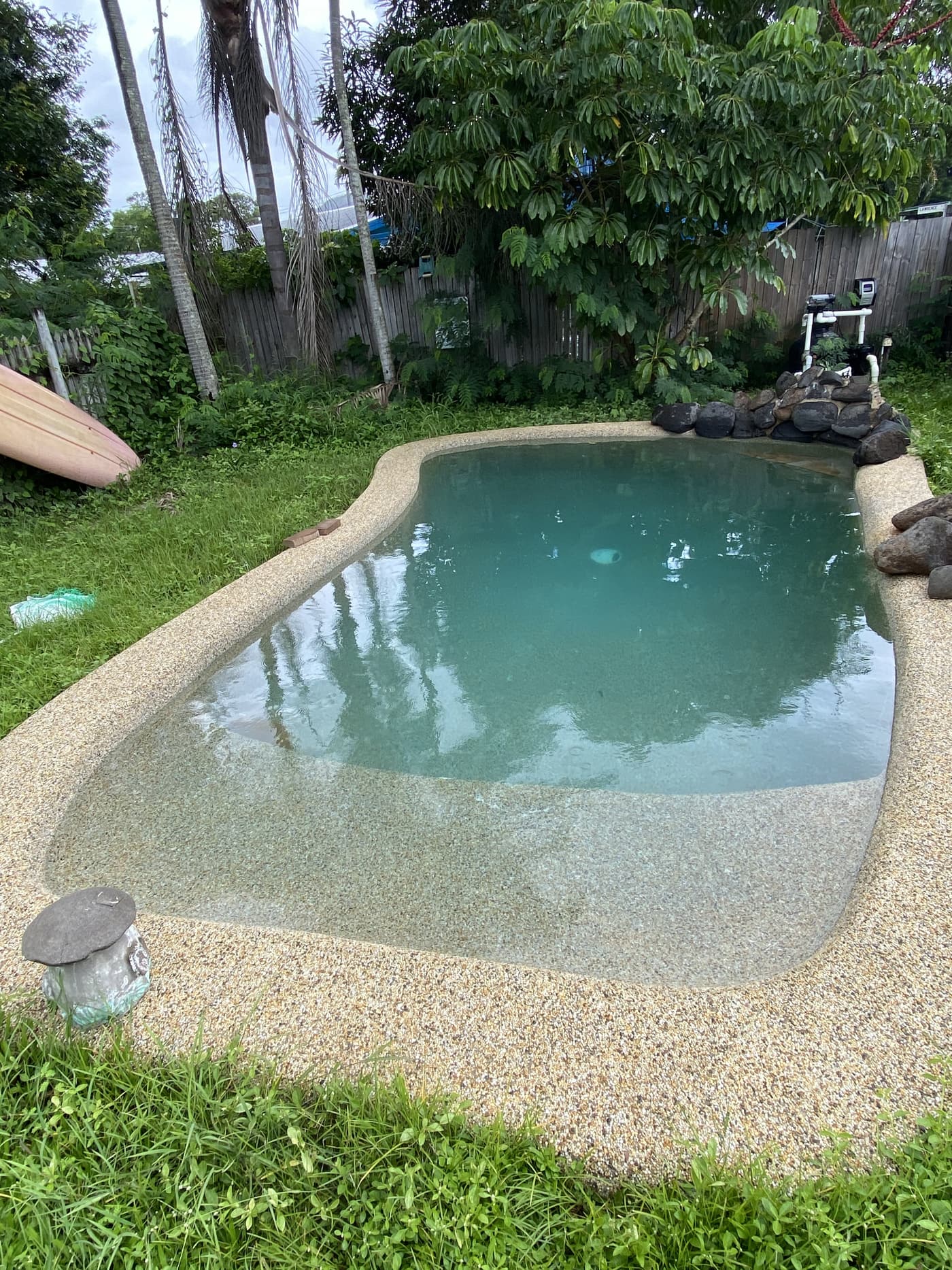 Kidney-shape pebblecrete pool in a Townsville backyard during a recent green-recovery job